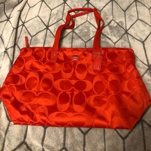 Large, red/ orange zip Coach weekender tote